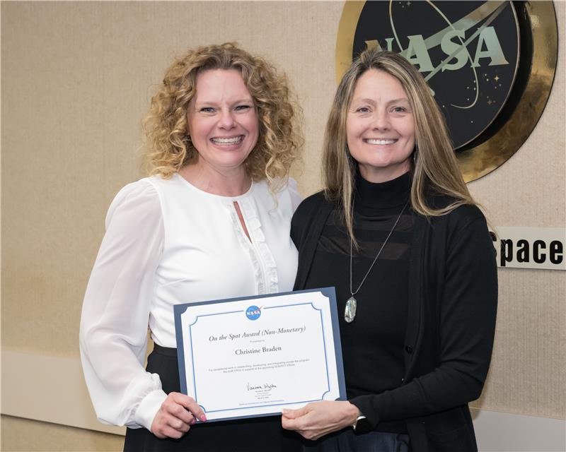 Christine Braden receives an “On the Spot” award from Angela Hart, program manager for NASA’s Commercial Low Earth Orbit Development Program, in March 2024 (Credit: NASA/Helen Arase Vargas).