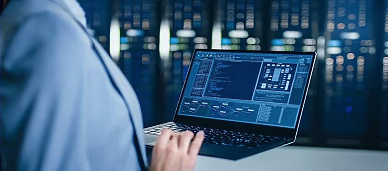 Stock photo of a man's hand on a laptop, with the screen showing code and diagrams, with the caption "DIP Team at ATCA Global Conference"