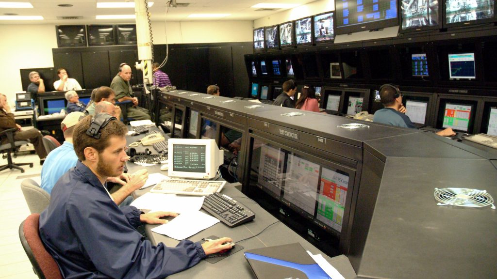 NASA Stennis test conductor Brian Childers sits at a workstation inside of Test Control Center during the 1000th test of a space shuttle main engine