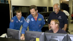 NASA astronaut Drew Feustal, far left, and Canadian Space Agency astronaut Chris Hadfield converse with engineers in the NASA Stennis Test Control Center