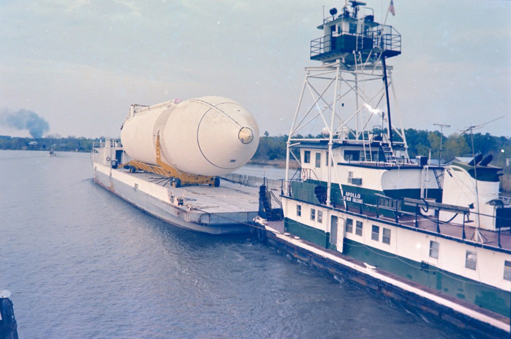 A space shuttle external fuel tank arrives by barge at NASA Stennis