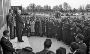 Two men on platform addressing crowd.