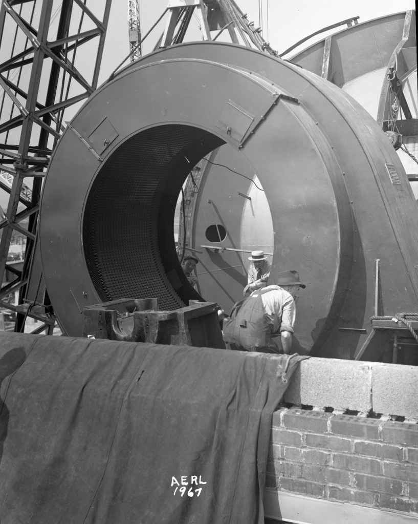 Men installing case for AWT drive motor.