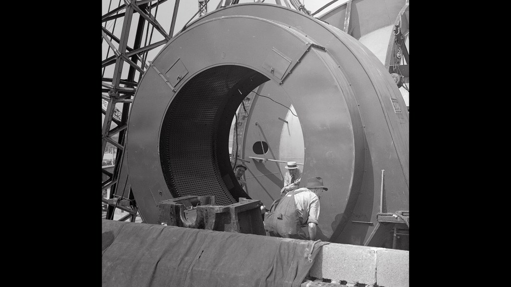 Men installing case for AWT drive motor.