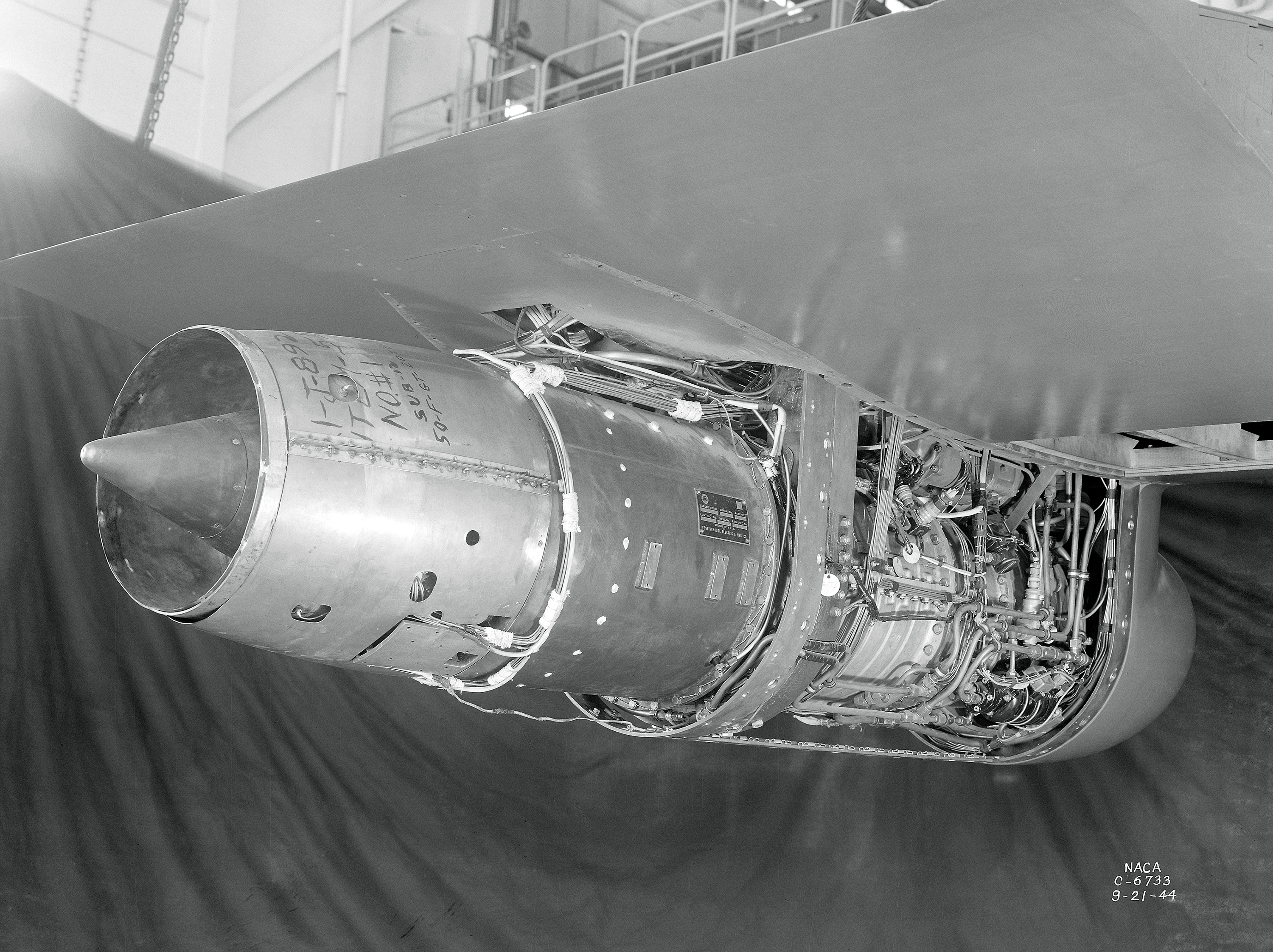 Westinghouse 19B suspended from wing span in AWT test section