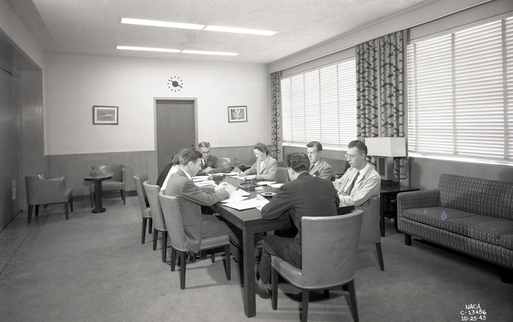 Group at table in conference room.
