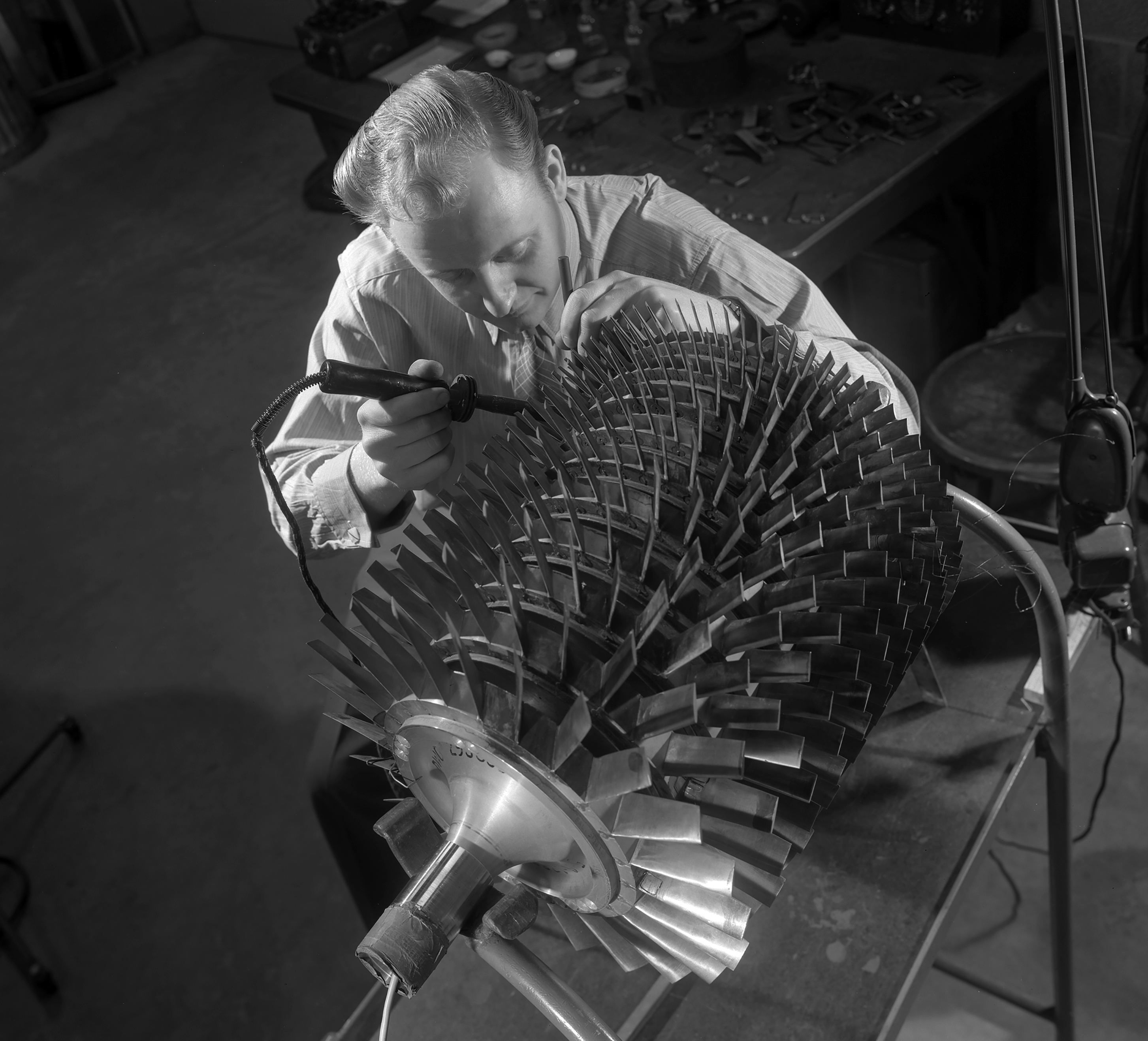 Overhead view of man working on compressor
