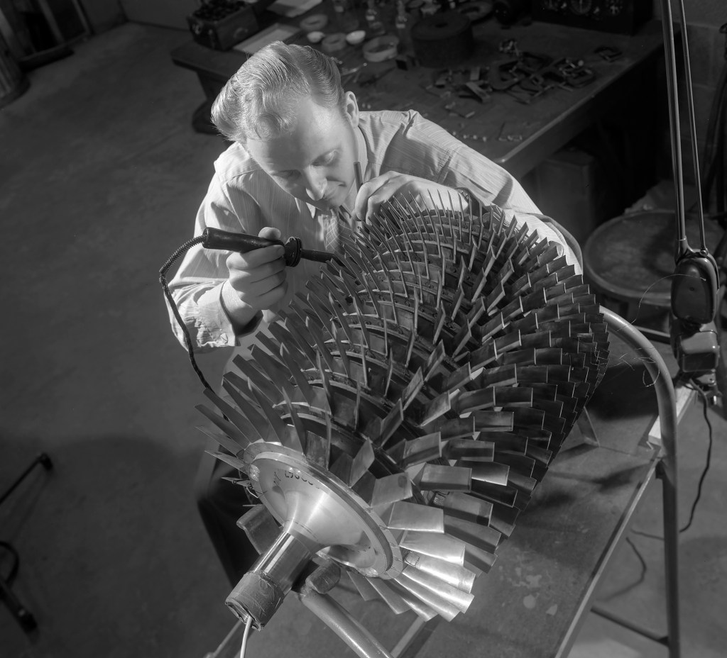 Overhead view of man working on compressor