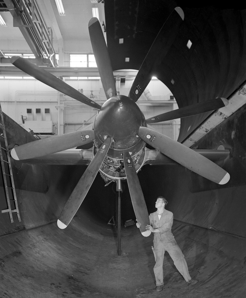 Mechanic rotates propeller on Python engine in AWT test section
