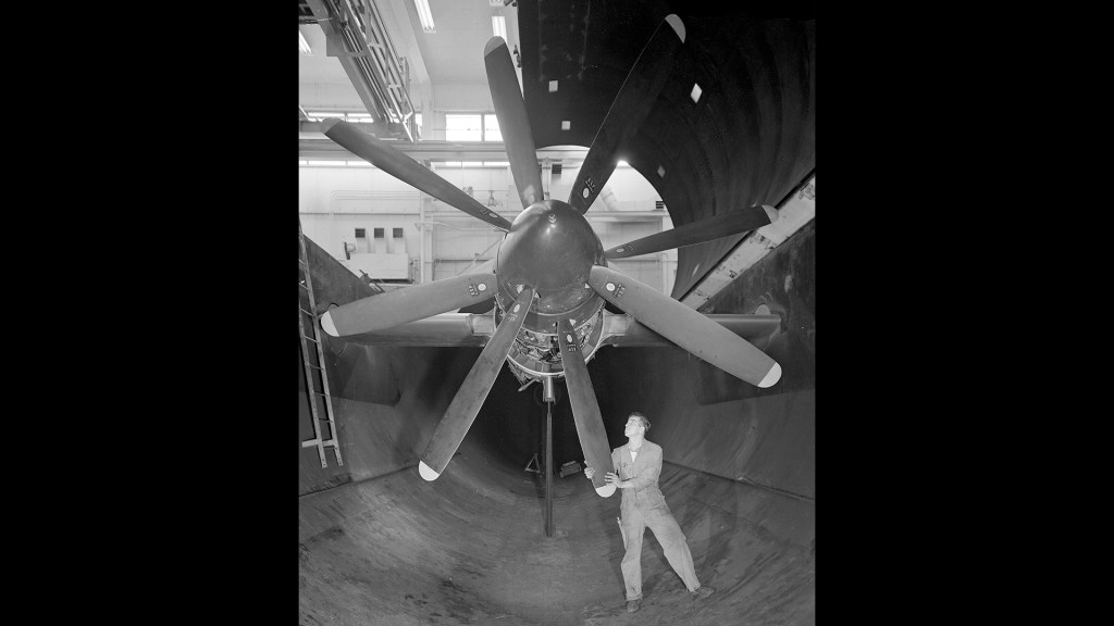 Mechanic rotates propeller on Python engine in AWT test section