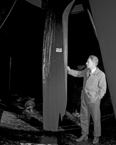 Man examines damaged wooden fan blade