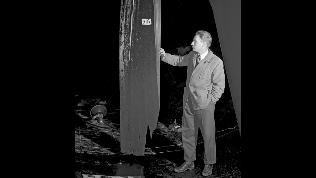 Man examines damaged wooden fan blade