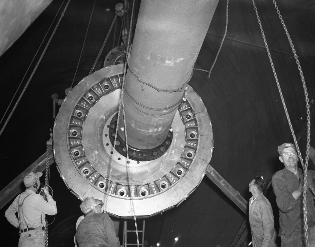 Workers with drive shaft.