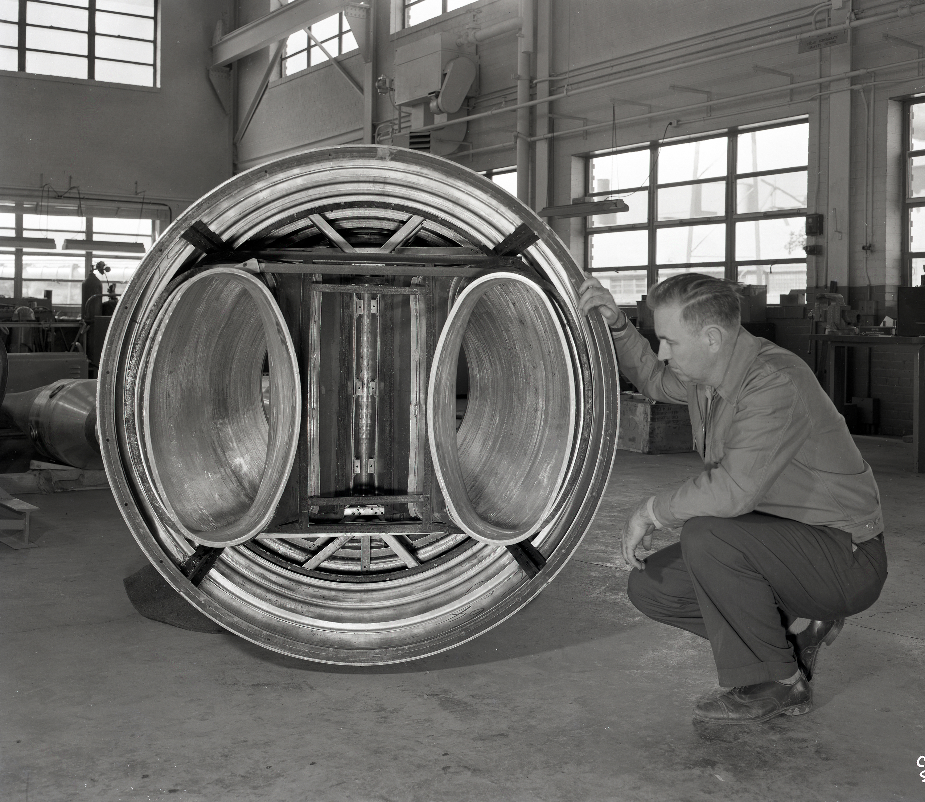 Man examining engine inlet duct.
