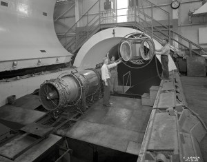 A rail crane lowers an inlet duct into the 20-foot diameter AWT test section