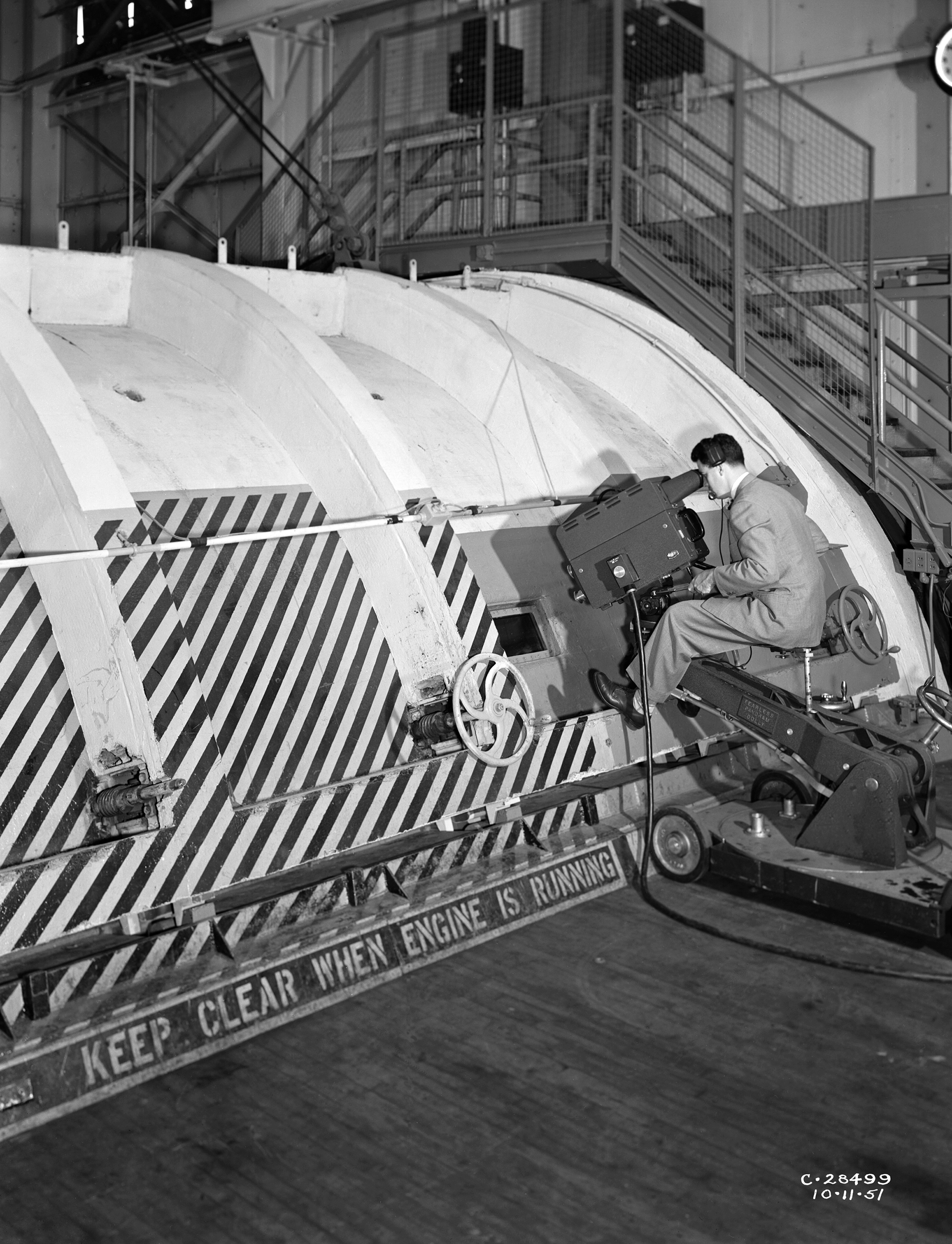 A mechanic examines the Allison T-38 inside the AWT's test section.