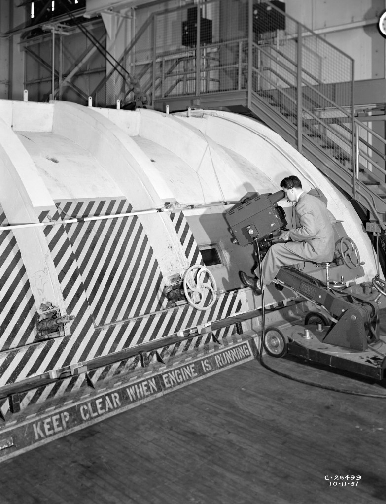 A mechanic examines the Allison T-38 inside the AWT's test section.