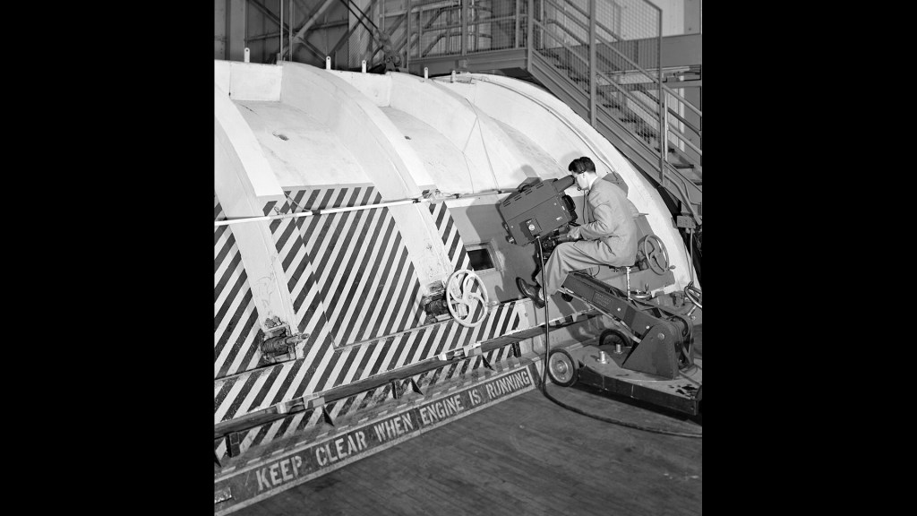 A mechanic examines the Allison T-38 inside the AWT's test section.