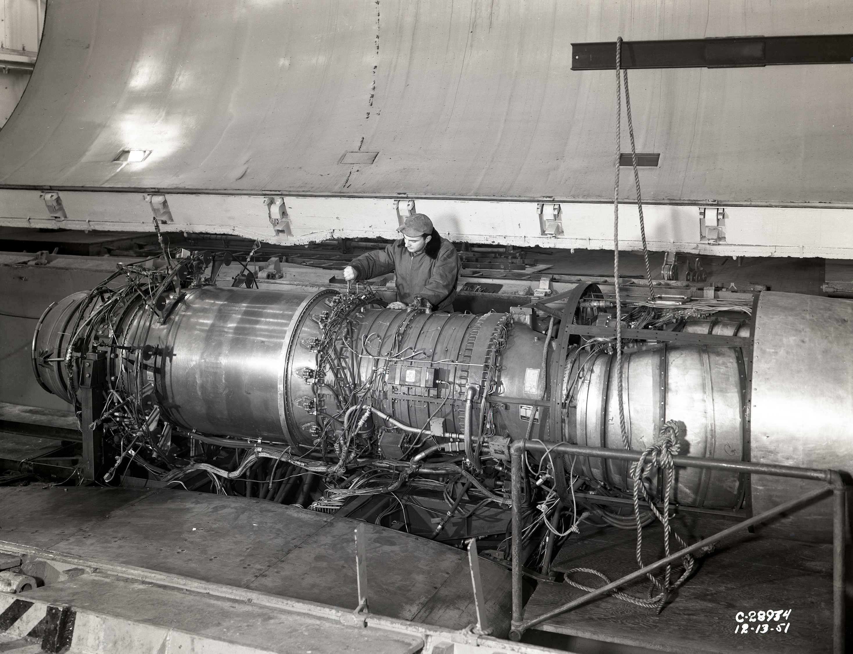Mechanic with engine in test section.