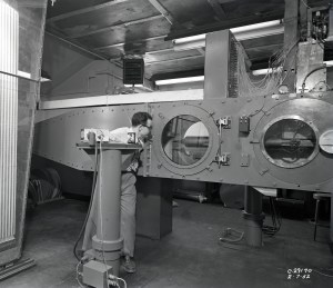 A researcher examines a small ramjet engine in 2x2-foot Supersonic Wind Tunnel
