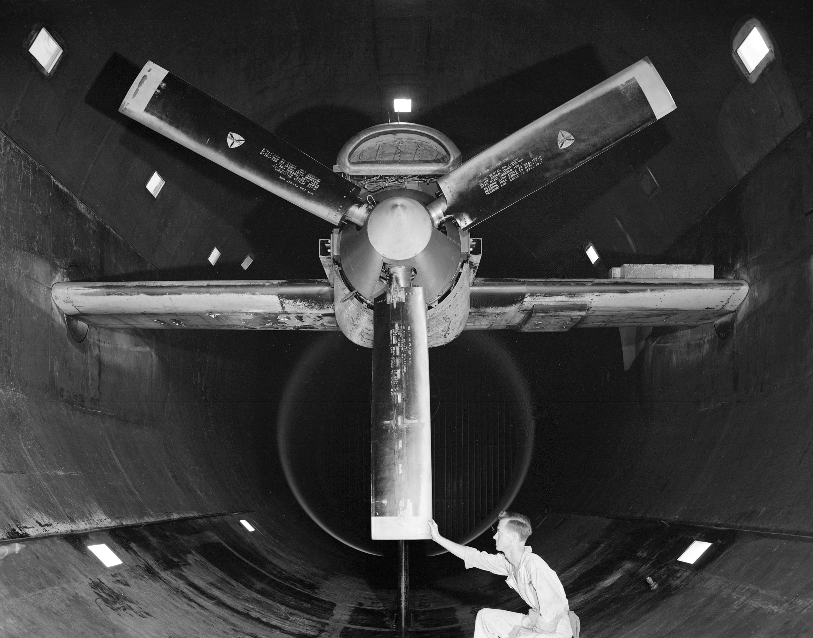 A mechanic examines the Allison T-38 inside the AWT's test section.