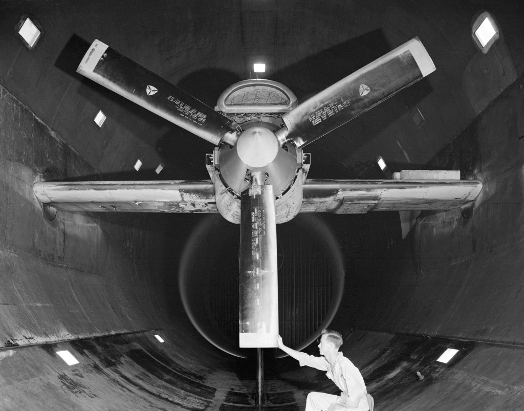 A mechanic examines the Allison T-38 inside the AWT's test section.