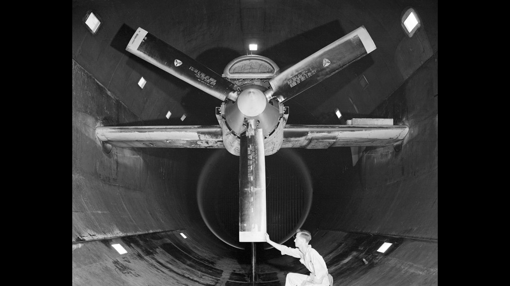 A mechanic examines the Allison T-38 inside the AWT's test section.