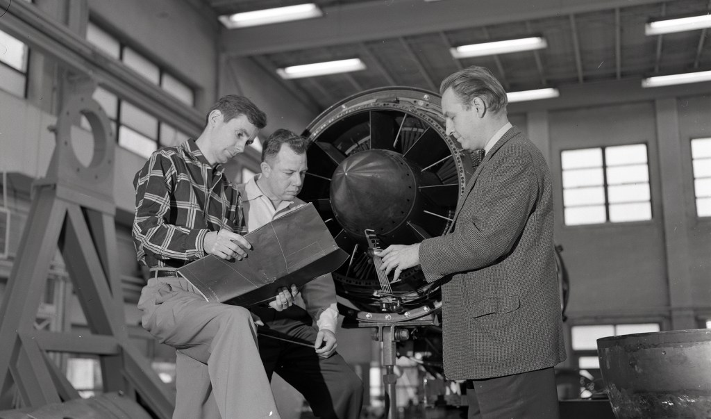 AWT personnel discuss test with Researcher in shop