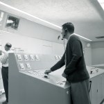 Two operators in control room.