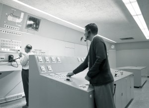 Two operators in control room.