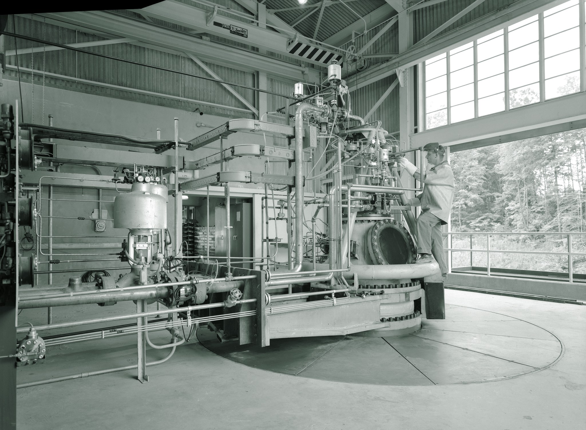 Mechanic working on RETF test stand.