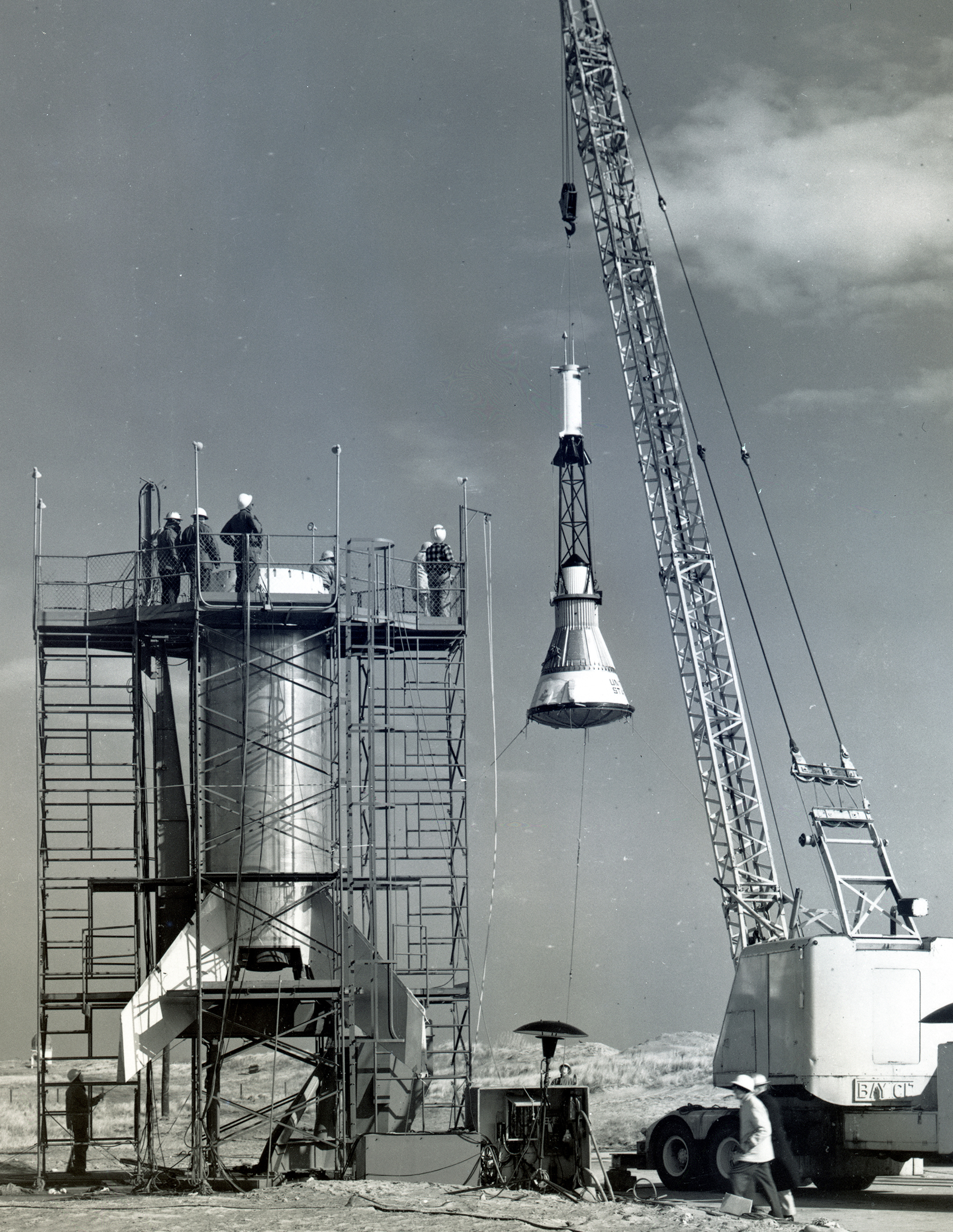 Lifting of Mercury capsule at launch pad.