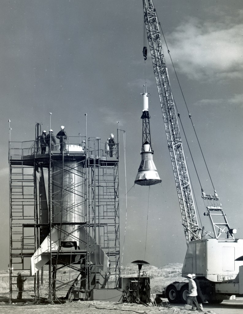 Lifting of Mercury capsule at launch pad.