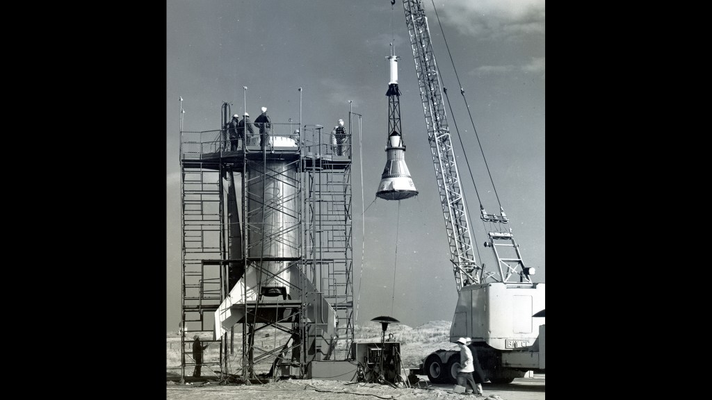 Lifting of Mercury capsule at launch pad.