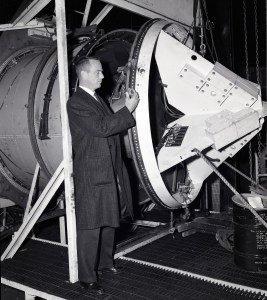 Scott Carpenter examining setup for capsule separation tests.