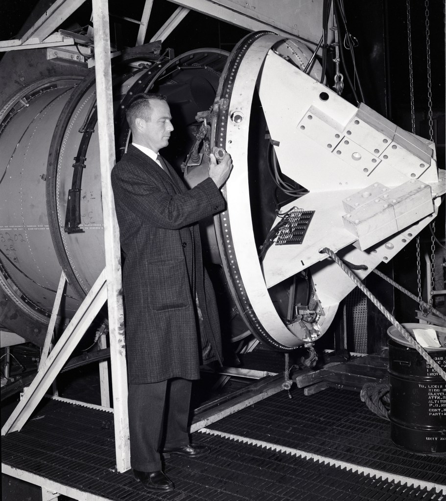 Scott Carpenter examining setup for capsule separation tests.