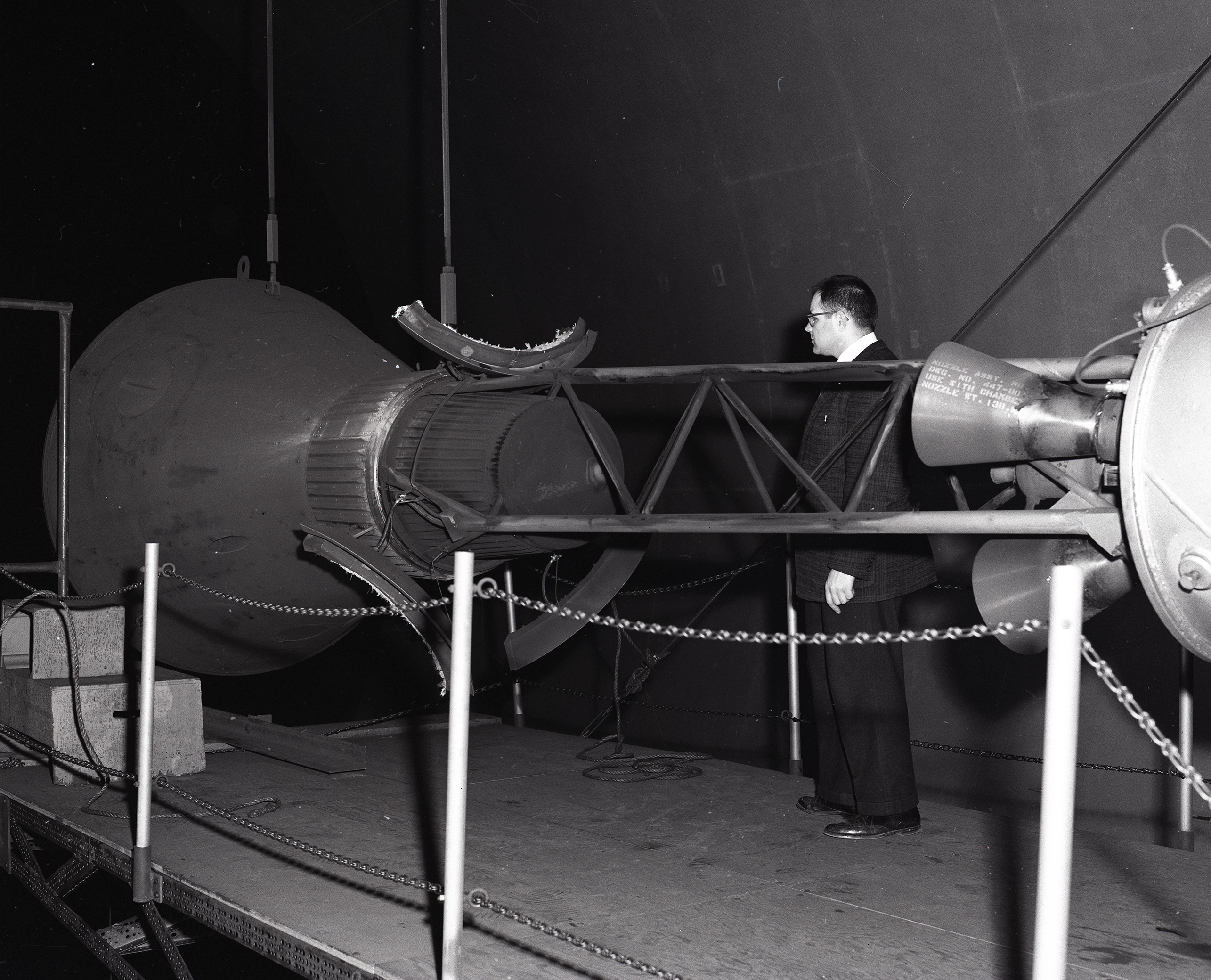 Researcher examines setup for Mercury capsule escape rocket test