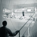 Men on catwalks viewing Mercury capsule.