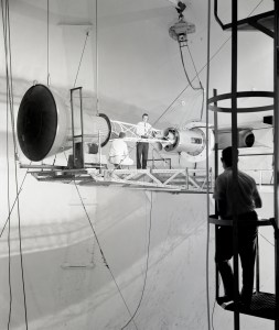 Engineers on platform work on capsule mounted on tunnel wall