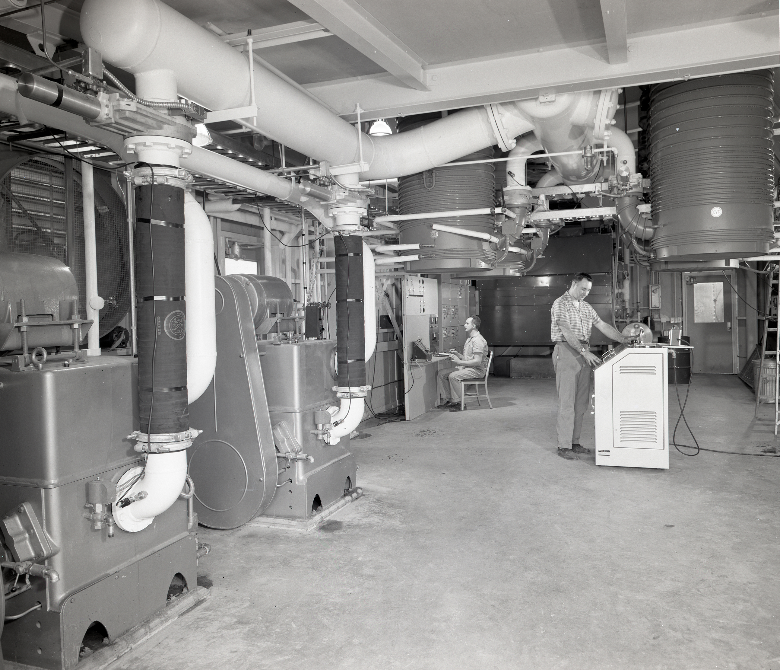 Men working inside Vacuum Pump House