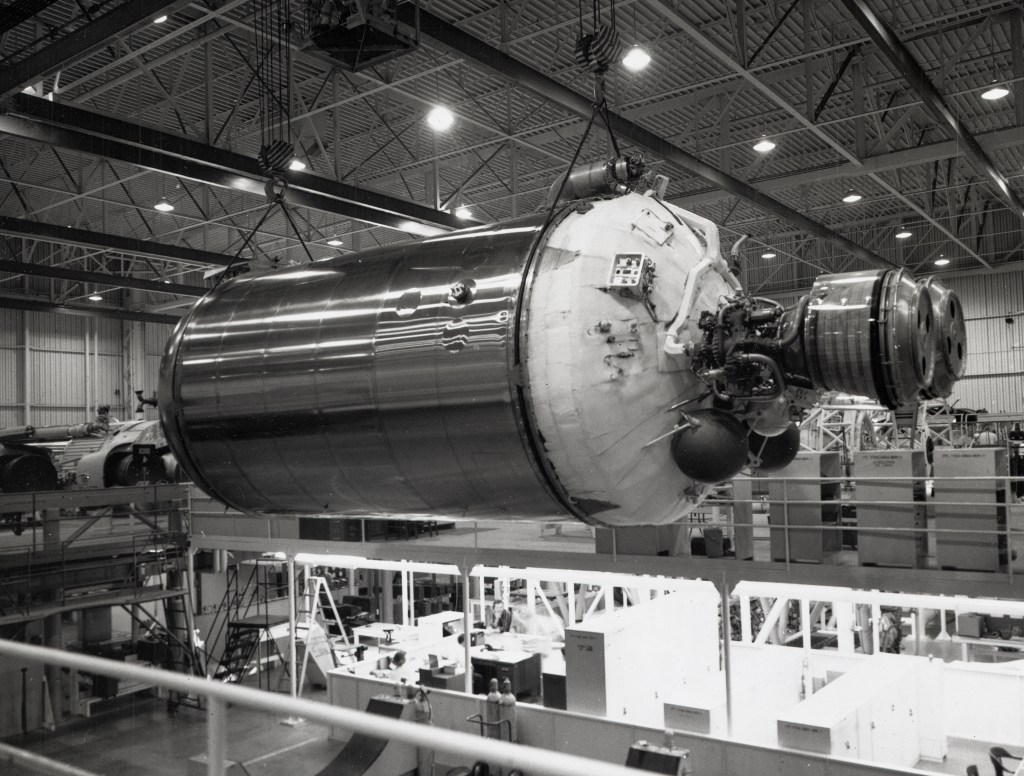 Centaur lifted horizontally by crane in factory