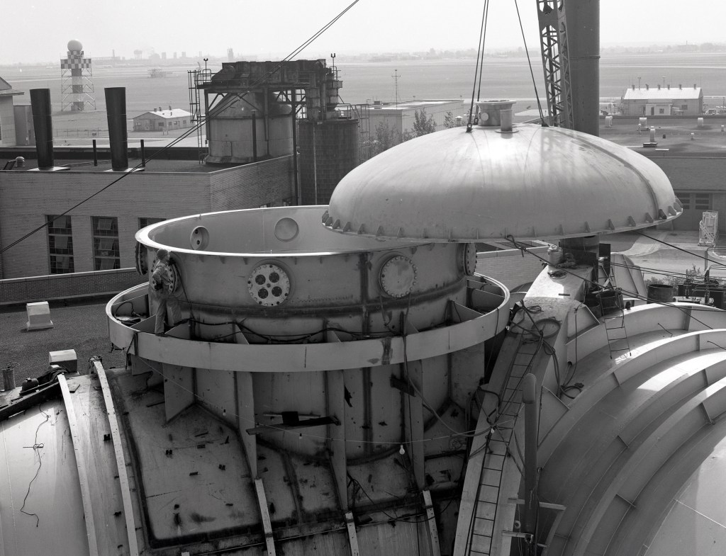 Crane lifts cap off the top of SPC No. 1 dome