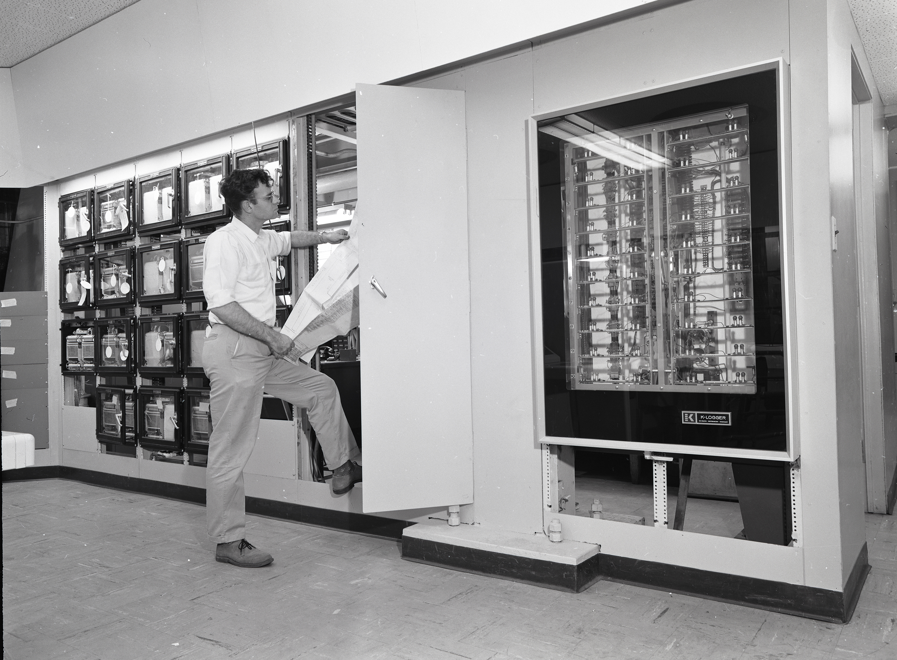 Man examines data recorders in control room