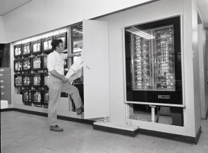 Man examines data recorders in control room