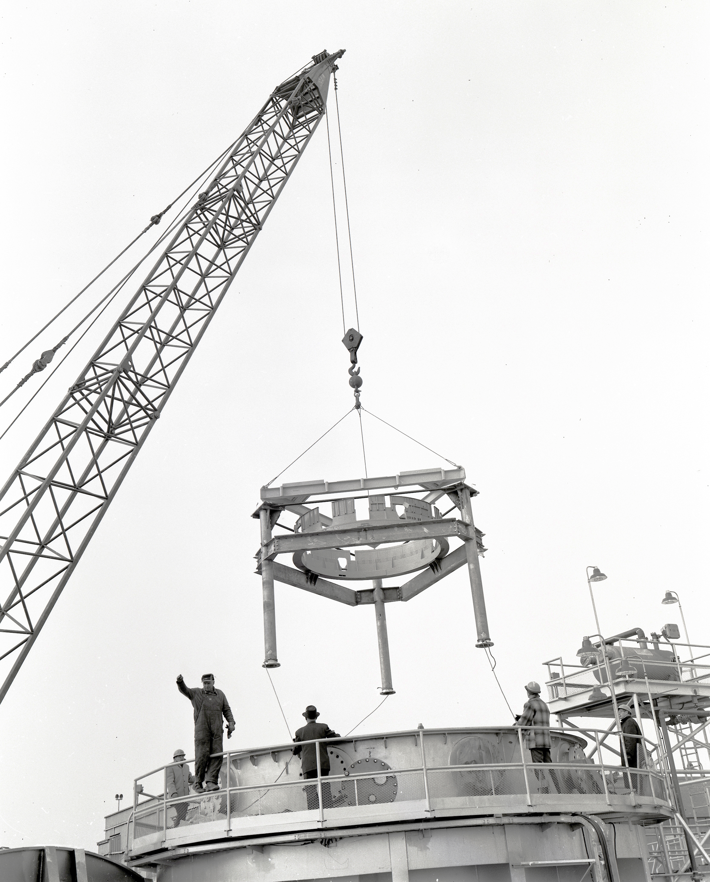 Crane lowering stand into test chamber.
