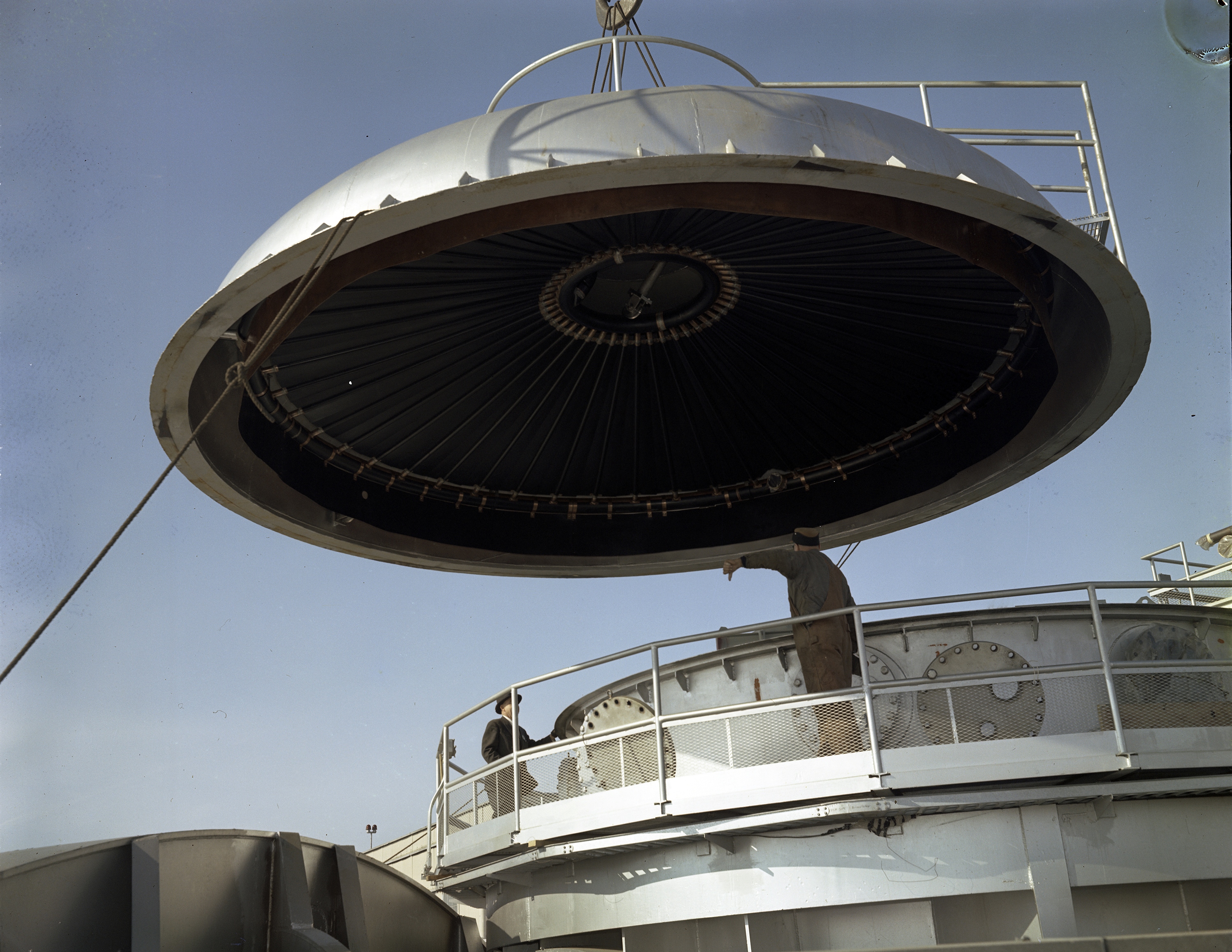 Crane lifting dome from chamber.