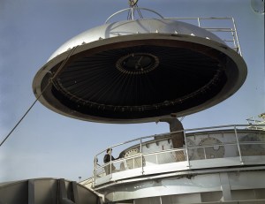 Crane lifting dome from chamber.