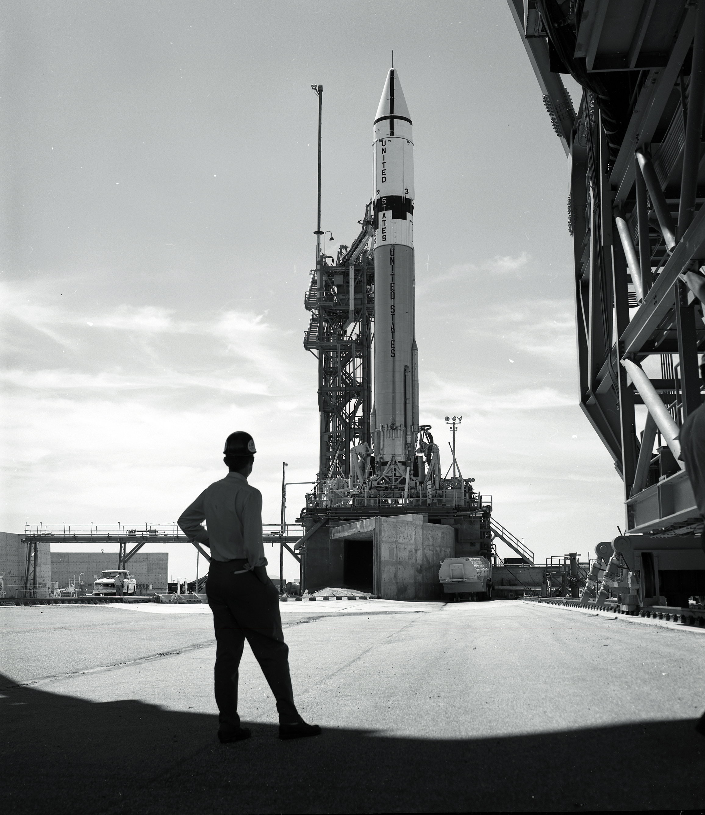 Man looking at rocket on launch pad.