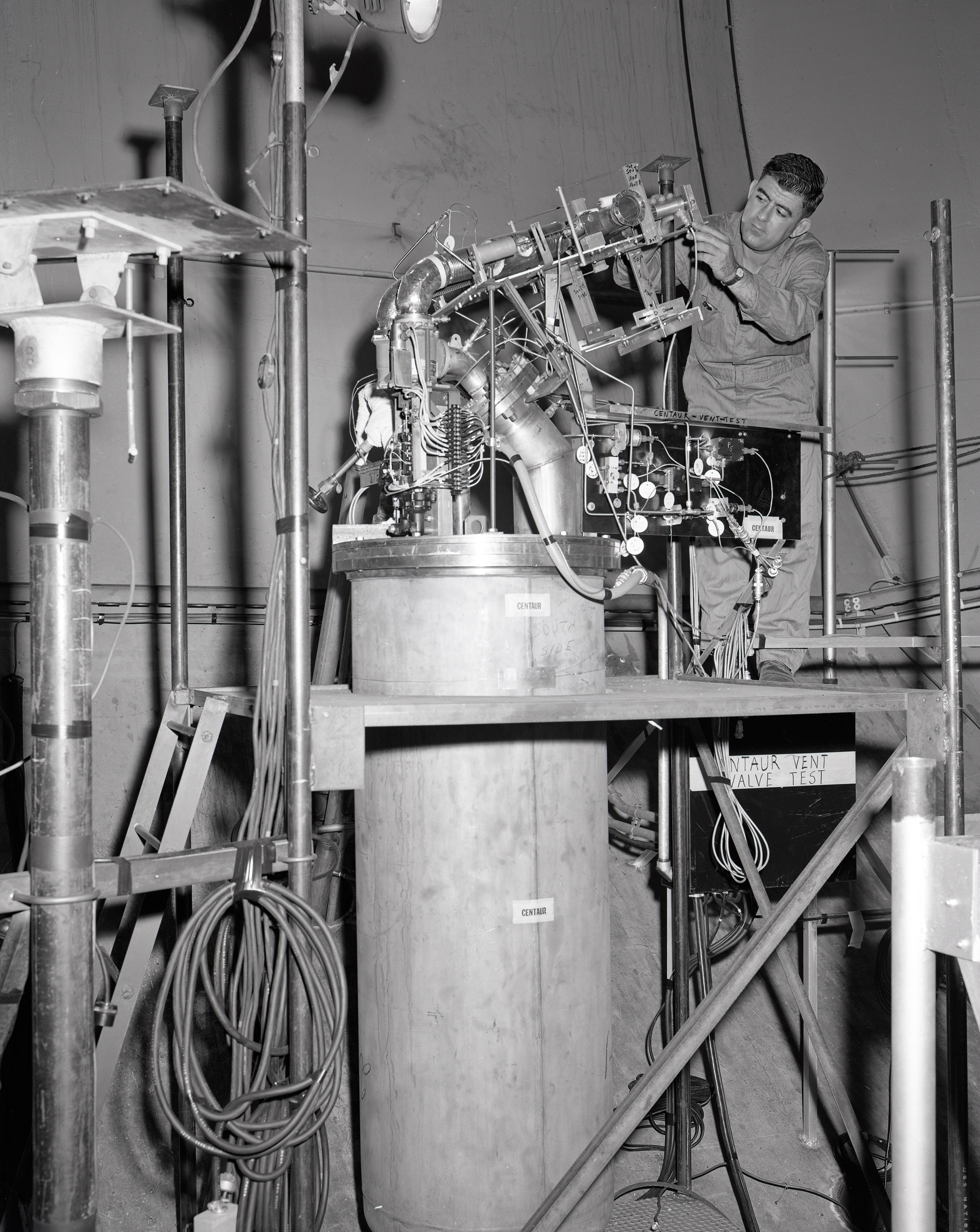 A technician installs a Centaur vent valve test rig in SPC No. 2.