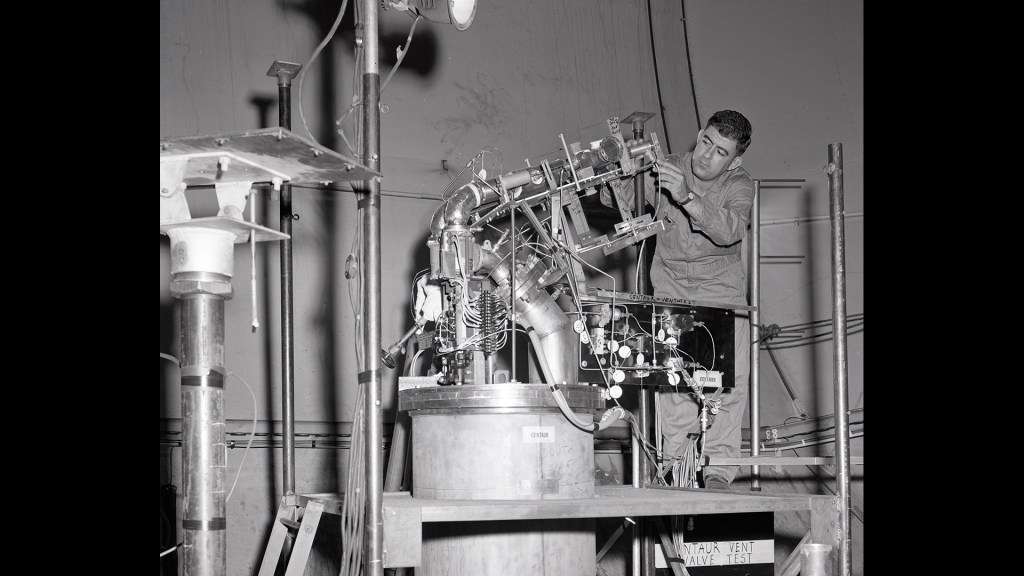 A technician installs a Centaur vent valve test rig in SPC No. 2.